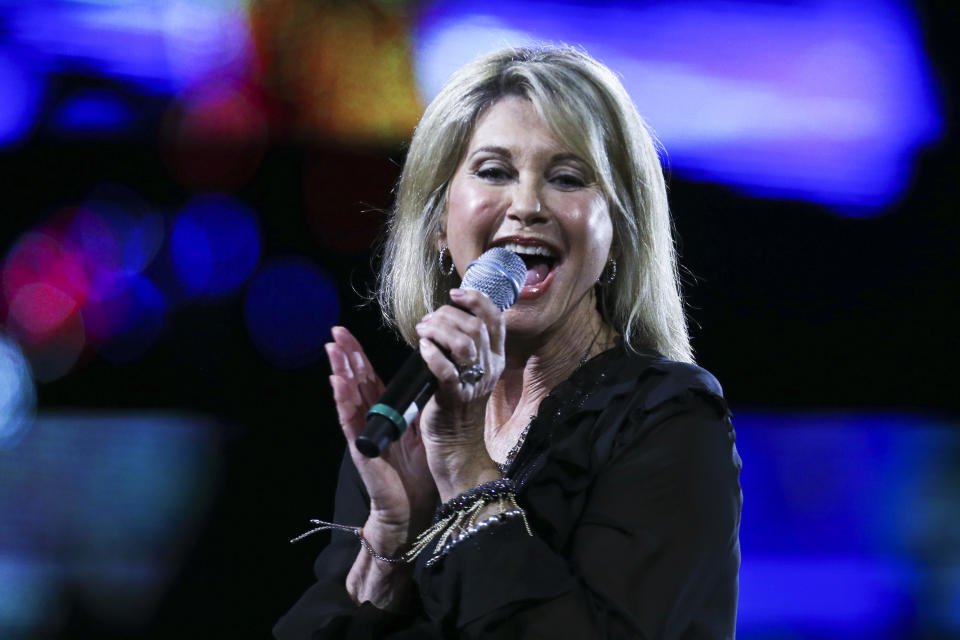 FILE - In this Feb. 23, 2017, file photo, Olivia Newton-John performs during the Viña del Mar International Song Festival at the Quinta Vergara in Viña del Mar, Chile. Newton-John said she has been diagnosed with cancer for the third time in three decades. The four-time Grammy winner, who will turn 70 on Sept. 26, told Australian news program “Sunday Night” doctors found a tumor in her lower back in 2017. (AP Photo/Esteban Felix, File)