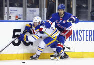 New York Rangers' Chris Kreider (20) checks Buffalo Sabres' Jacob Bryson (78) into the boards during the third period of an NHL hockey game Tuesday, April 27, 2021, in New York. (Bruce Bennett/Pool Photo via AP)