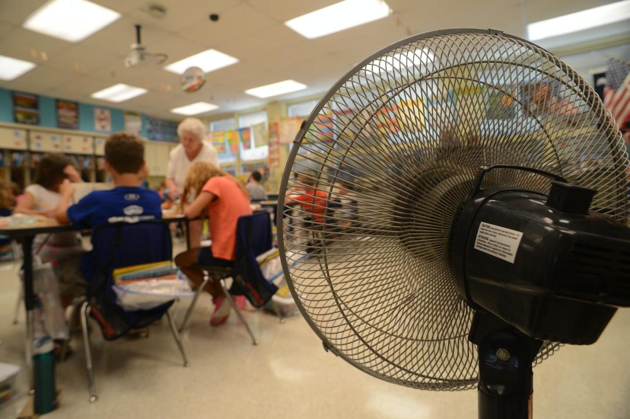 Climate change means more schools will need to install or upgrade cooling systems. <a href="https://www.gettyimages.com/detail/news-photo/hot-schools-a-fan-attempts-to-cool-the-classroom-of-east-news-photo/1316260189" rel="nofollow noopener" target="_blank" data-ylk="slk:Bill Uhrich/MediaNews Group/Reading Eagle via Getty Images;elm:context_link;itc:0;sec:content-canvas" class="link ">Bill Uhrich/MediaNews Group/Reading Eagle via Getty Images</a>