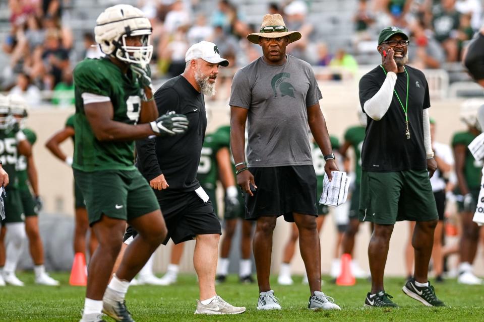 From left, Michigan State's defensive coordinator Scottie Hazelton, head coach Mel Tucker and tight ends coach Ted Gilmore look on during the Meet the Spartans open practice on Monday, Aug. 23, 2021, at Spartan Stadium in East Lansing.