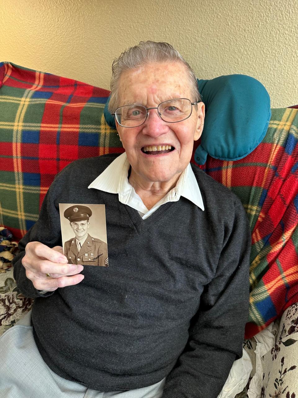 Dr. Marvin Lee Lykins hold a photo of a younger Lykins during his military time after an interview with The Stockton Record on Jan. 25, 2024.