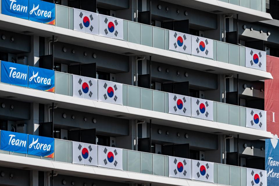 South Korea flags and signage are displayed at the Olympic and Paralympic Village in Tokyo on July 15, 2021, ahead of the 2020 Tokyo Olympic Games which begins on July 23.