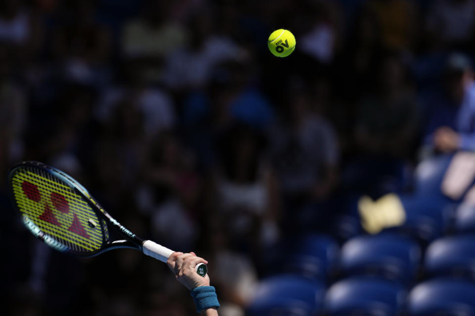 Aryna Sabalenka of Belarus serves to Belinda Bencic of Switzerland during their fourth round match at the Australian Open tennis championship in Melbourne, Australia, Monday, Jan. 23, 2023. (AP Photo/Aaron Favila)