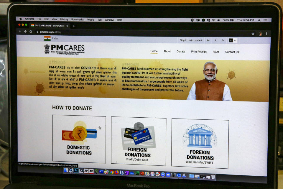 The website of the Prime Minister’s Citizen Assistance and Relief in Emergency Situations Fund, or the PM CARES fund, is seen on a computer screen in Kolkata, India, Thursday, July 9, 2020. From industrialists and foreign companies to celebrities and ordinary citizens, people from all walks of life pitched in for a newly created fund touted to strengthen India’s fight against the deadly virus the next day. More than three months later, the PM CARES fund, is now valued at more than $1 billion but has since run into controversy over an alleged lack of transparency and accountability, along with a general lack of clarity over the control, the donors and the use of money donated to it. (AP Photo/Bikas Das)