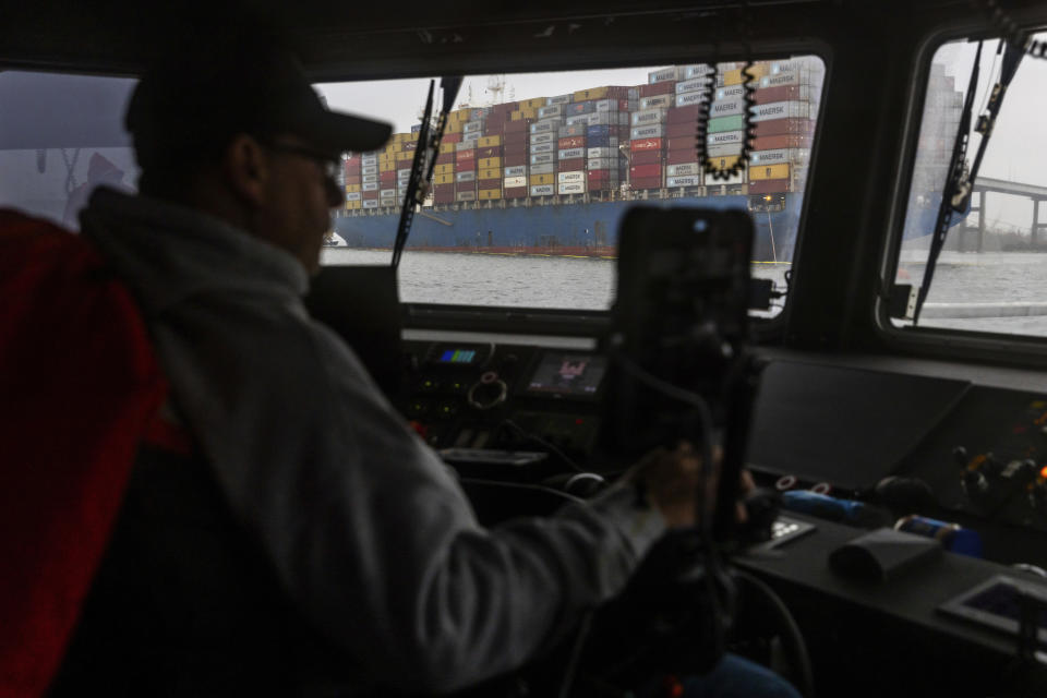 Army Corps of Engineers Small Craft Captain Robert Kilchenstein navigates USACE Catlett towards the collapsed Francis Scott Key Bridge, Wednesday, April 3, 2024, in Baltimore. (AP Photo/Julia Nikhinson)