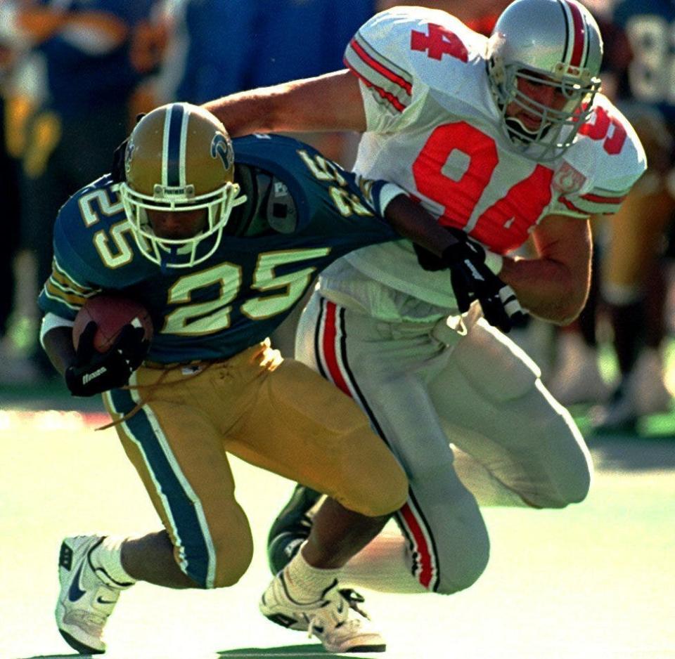 Ohio State defensive end Mike Vrabel (94) pulls down Pittsburgh running back Demetrius Harris (25) on Sept. 30, 1995.