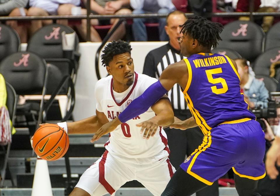 Jan 19, 2022; Tuscaloosa, Alabama, USA; Alabama Crimson Tide forward Noah Gurley (0) controls the ball against LSU Tigers forward Mwani Wilkinson (5) during the first half at Coleman Coliseum. Mandatory Credit: Marvin Gentry-USA TODAY Sports