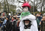 A protestor wears a costume as he marches during a demonstration against COVID-19 measures in Brussels, Sunday, Jan. 23, 2022. Demonstrators gathered in the Belgian capital to protest what they regard as overly extreme measures by the government to fight the COVID-19 pandemic, including a vaccine pass regulating access to certain places and activities and possible compulsory vaccines.(AP Photo/Geert Vanden Wijngaert)