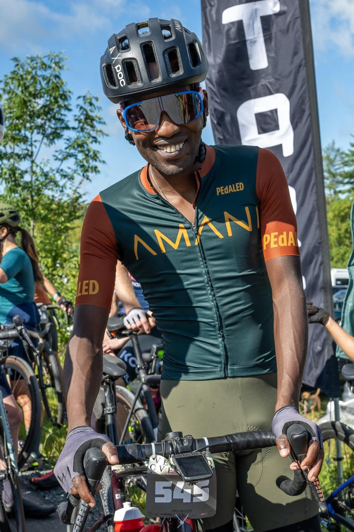 In this photo provided by Joseph Viger, Kenyan cyclist Sule Kangangi poses for a picture at a gravel race, in Vermont, Saturday, Aug. 27, 2022. Kangangi died in a crash later in the day, while competing in the race. (Joseph Viger via AP)