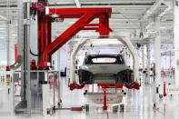 FILE PHOTO -- The body of a Tesla Model S is lifted by an automated crane at the Tesla factory in Fremont, California October 1, 2011. REUTERS/Stephen Lam/File Photo