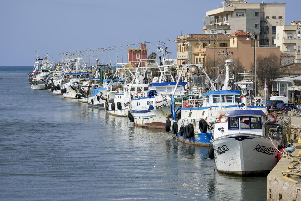 Fishing boats are lined up at harbor in the Roman port of Fiumicino, Friday, March 11, 2022. Fishermen, facing huge spikes in oil prices, stayed in port, mending nets instead of casting them. Nowhere more than in Italy, the European Union’s third-largest economy, is dependence on Russian energy taking a higher toll on industry.(AP Photo/Andrew Medichini)