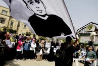 A supporter of ousted President Mohammed Morsi holds a flag with a photo of Ali Mohammed, who was killed at a protest, during a demonstration inside Cairo University in Egypt, Monday, March 24, 2014. A court in Egypt on Monday sentenced to death 529 supporters of Morsi on charges of murdering a policeman and attacking police, convicting them after only two sessions in one of the largest mass trials in the country in decades. (AP Photo/Ahmed Abd El Latef, El Shorouk) EGYPT OUT