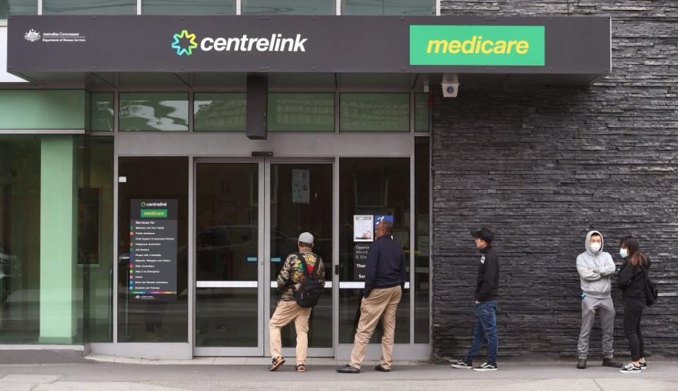 People queue outside an Australian government welfare centre, Centrelink, in Melbourne on March 23, 2020. (Photo by William WEST / AFP) (Photo by WILLIAM WEST/AFP via Getty Images)