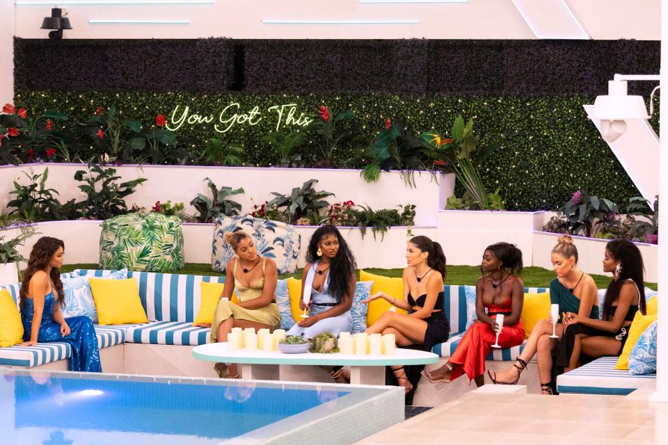 Maura Higgins talking to contestants of "Love Island USA" season five: Hannah Wright, Imani Wheeler, Kassandra Castillo, Vickala Gray, Carmen Kocourek and Destiny Davis.