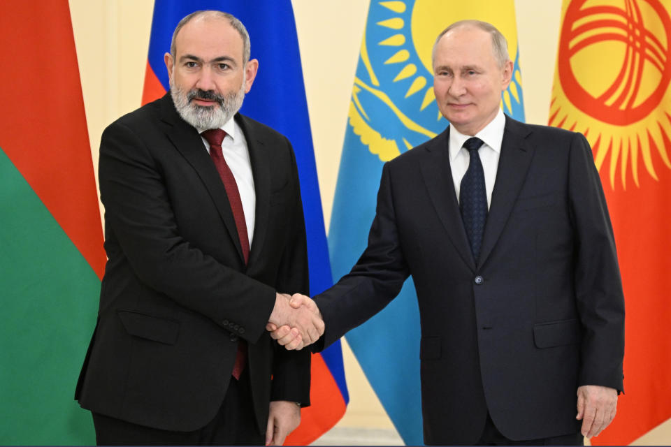 Russian President Vladimir Putin, right, and Armenian Prime Minister Nikol Pachinian shake hands on the sidelines of the Supreme Eurasian Economic Council in St. Petersburg, Russia, Monday, Dec. 25, 2023. (Pavel Bednyakov, Sputnik, Kremlin Pool Photo via AP)