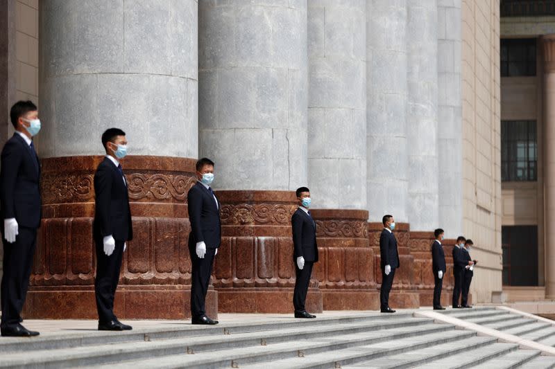 Security personnel stand guard outside the Great Hall of the People in Beijing