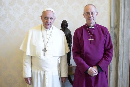 Pope Francis (L) poses with the Archbishop of Canterbury Justin Welby during a private meeting at the Vatican June 16, 2014. REUTERS/Osservatore Romano