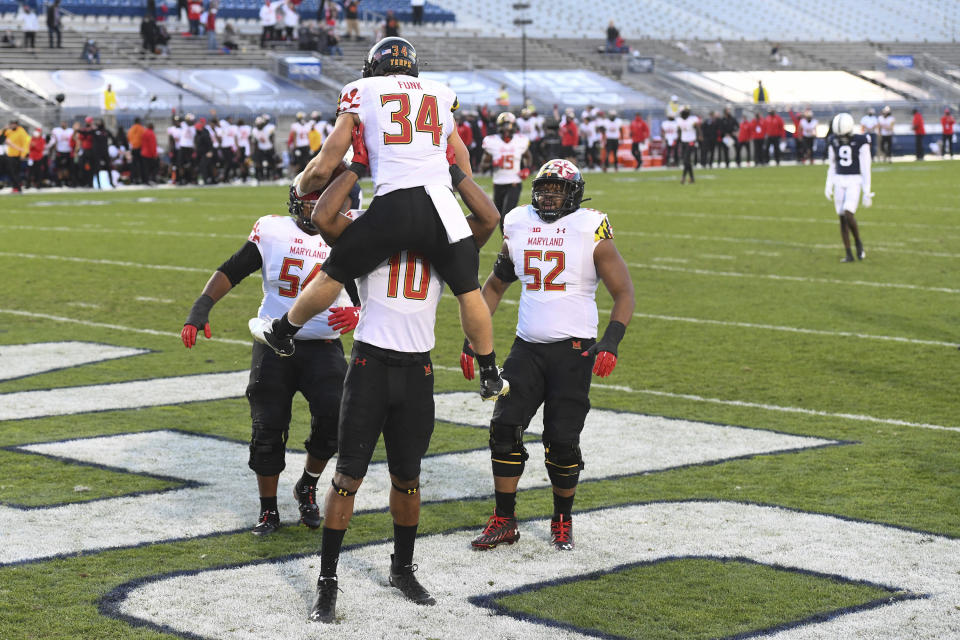Maryland running back Jake Funk (34) celebrates his second-quarter touchdown run with teammates during an NCAA college football game against Penn State in State College, Pa., Saturday, Nov. 7, 2020. (AP Photo/Barry Reeger)