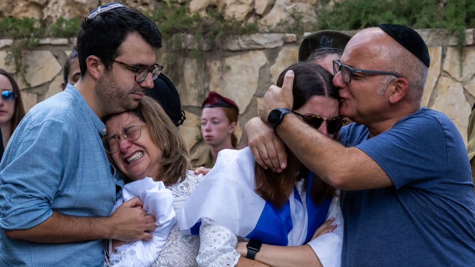 The mother (L), sister (R) and immediate family of Valentin (Eli) Ghnassia, 23, who was killed in a battle with Hamas militants at Kibbutz Be'eeri near the Israeli border with the Gaza Strip, react during his funeral,  October 12, 2023 in Jerusalem, Israel.  - Alexi J. Rosenfeld/Getty Images