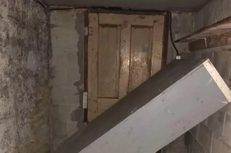 A large cabinet blocked off the basement door