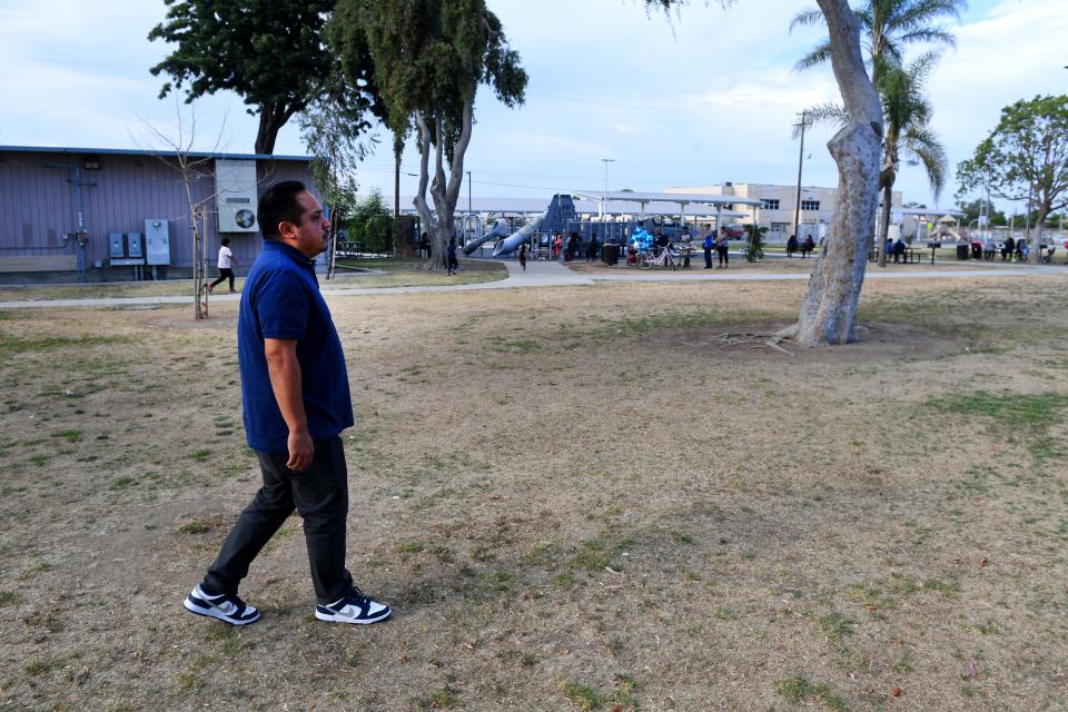 Oxnard City Councilman Oscar Madrigal walks through La Colonia Park near his home in the La Colonia neighborhood Aug. 9.