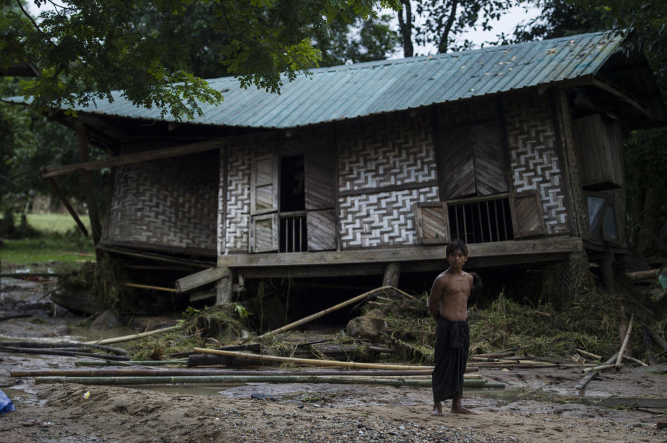 <p>A flood victim stands in front of a house damaged by rampaging flood waters from Swar Chaung Dam in Swar township in Bago region in Myanmar on Aug. 30, 2018. (Photo: Ye Aung Thu/AFP/Getty Images) </p>