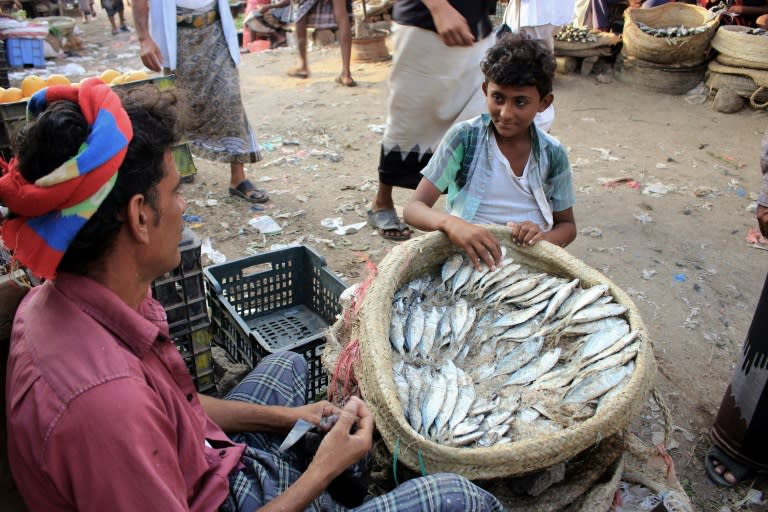 A man sells fish at a market in the northern district of Abs in Yemen's northwestern Hajjah province on November 13, 2018