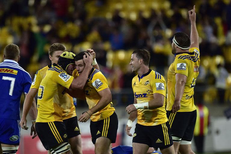 (L-R) Wellington Hurricanes' Adam Hill, James Marshall Cory Jane and Jeremy Thrush celebrate their win against the Western Stormers during the Super 15 rugby match at Westpac Stadium on April 3, 2015