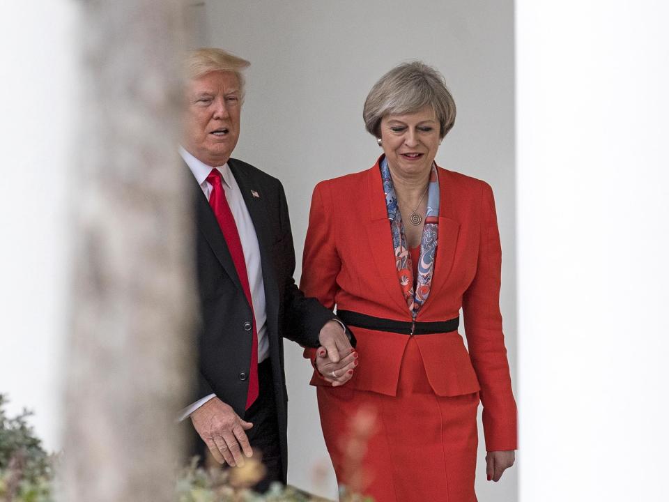 Theresa May was photographed holding hands with the US President at the White House in January. One explanation for gesture was that Donald Trump was afraid of a slope: Getty