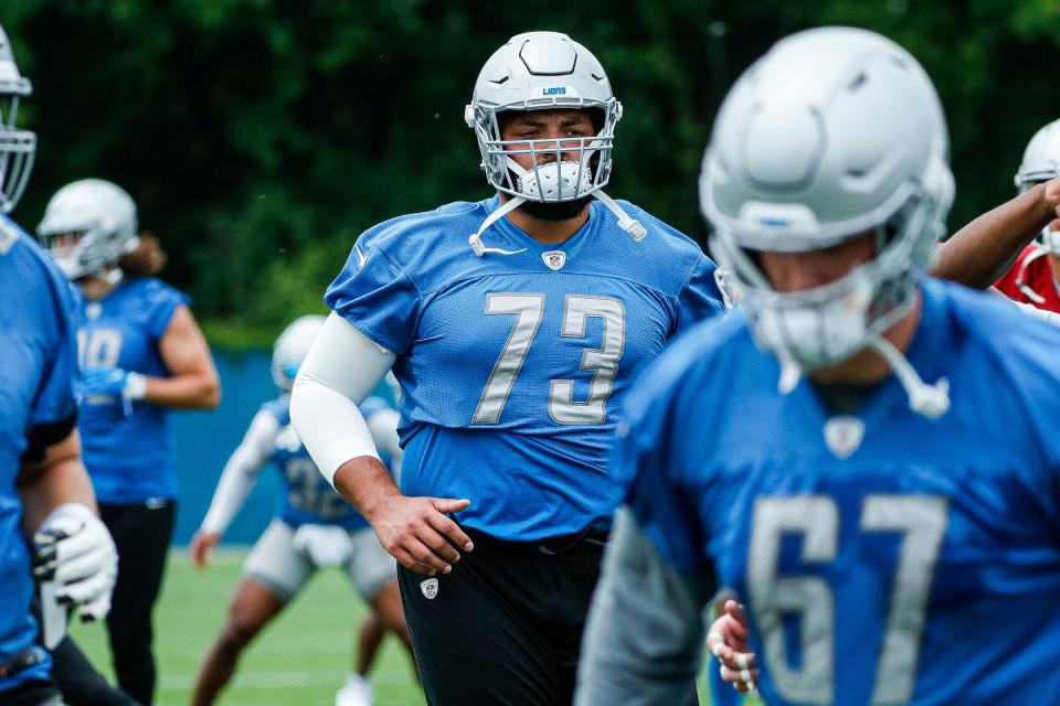 Lions offensive lineman Jonah Jackson, center, warms up during minicamp in Allen Park on Wednesday, June 8, 2022.