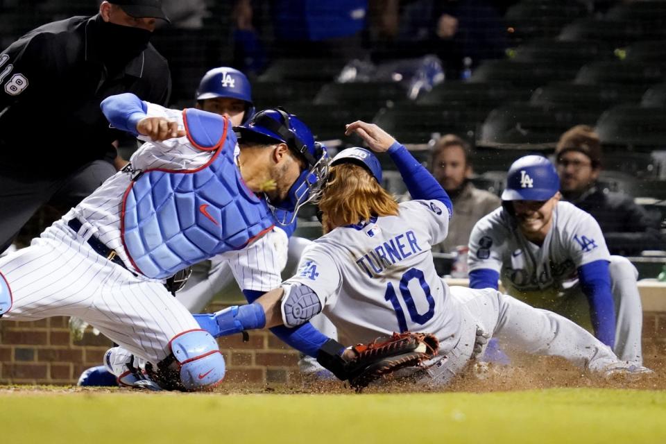 Catcher tagging out player at home plate