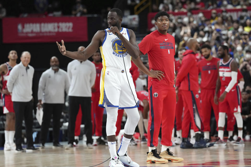 Golden State Warriors' Draymond Green, left, and Washington Wizards' Rui Hachimura, right, speak prior to a preseason NBA basketball game between Golden State Warriors and Washington Wizards Sunday, Oct. 2, 2022, at Saitama Super Arena, in Saitama, north of Tokyo. (AP Photo/Eugene Hoshiko)