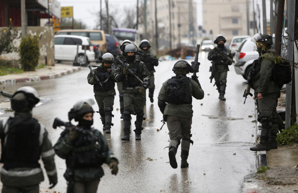 FILE - In this Wednesday, Jan. 9, 2019 file photo, Israeli forces deploy during a raid in the West Bank City of Ramallah. Israel has been launching raids into the heart of Ramallah, and the U.S. is cutting off aid and taking actions that many fear will obliterate any remaining hope for a two-state solution. (AP Photo/Majdi Mohammed, File)