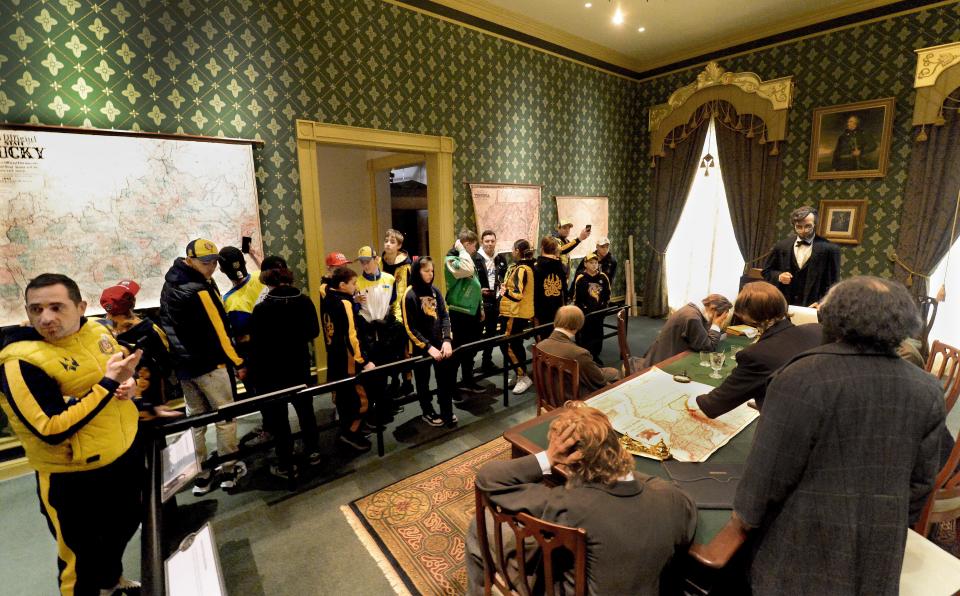 Members of a Ukrainian youth hockey team look at a display of Lincoln's cabinet reacting to the first reading of the Emancipation Proclamation while visiting the Abraham Lincoln Presidential Library and Museum in Springfield Thursday, March 23, 2023.