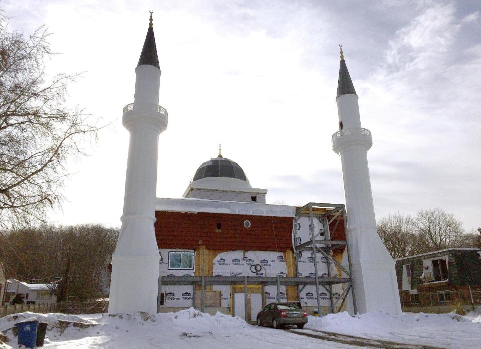 Construction at a mosque being built with support from the Turkish-American Religious Foundation sits suspended, Tuesday, Feb. 14, 2017, in New Haven, Conn. The city halted construction of a mosque in November because two minarets sent from Turkey are 24 feet too tall. City officials say it's up to the mosque owner, the Turkish-American Religious Foundation, to figure out how to make the 81-foot-tall towers smaller. (AP Photo/Michael Melia)