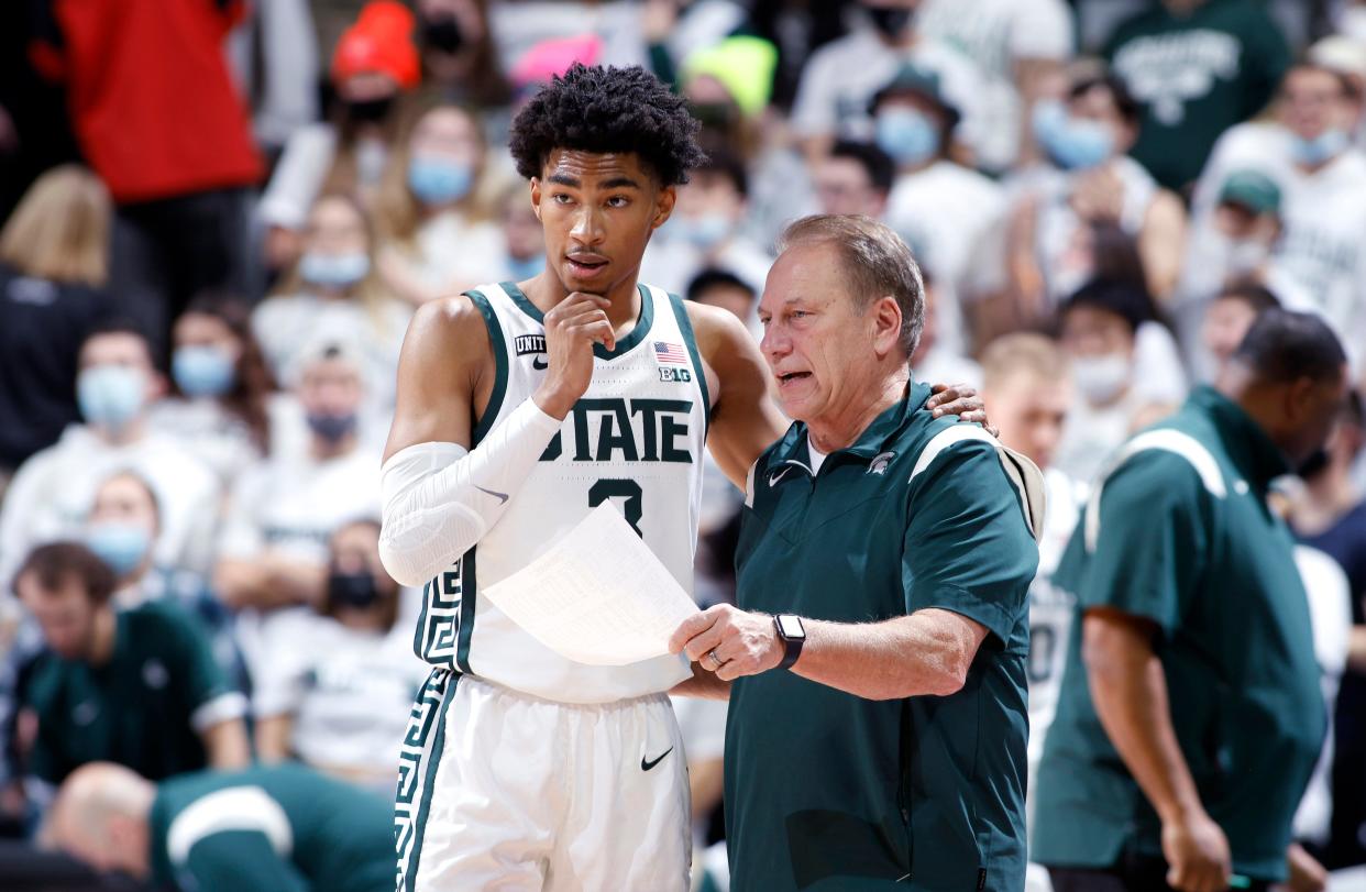 Michigan State coach Tom Izzo, right, talks with Jaden Akins during the first half of an NCAA college basketball game against Toledo, Saturday, Dec. 4, 2021, in East Lansing, Mich. Michigan State won 81-68.