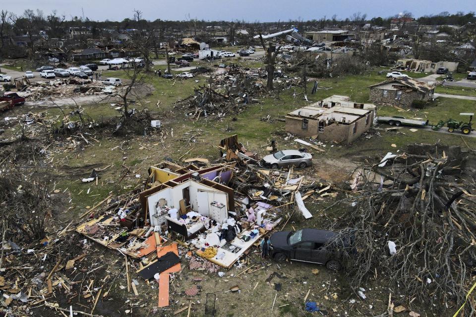 FILE - Debris is strewn around tornado damaged homes, Sunday, March 26, 2023, in Rolling Fork, Miss. A new study says warming will fuel more supercells or tornados in the United States and that those storms will move eastward from their current range. (AP Photo/Julio Cortez, File)