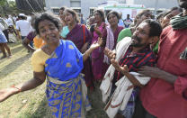 Indians mourn the death of relatives in a case of suspected food poisoning at Hanur, near Sulawadi village in Chamarajnagar district of Karnataka state, India, Saturday, Dec. 15, 2018. Police on Saturday arrested three people after at least 10 died of suspected food poisoning following a ceremony to celebrate the construction of a new Hindu temple in southern India. (AP Photo/Madhusudhan Sr)