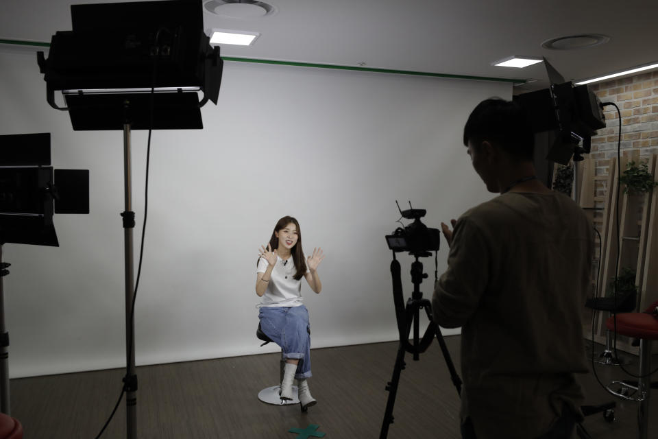 In this Sept. 5, 2019, photo, Kang Na-ra, 22, waves her hands during a YouTube program at a studio in Seoul, South Korea. In South Korea, a handful of young North Korean refugees have launched YouTube channels in recent years to offer a rare glimpse into life in the North. Kang, a North Korean escapee who regularly appears on two YouTube channels and two TV programs, is called “Princess Na-ra” by her fans. (AP Photo/Lee Jin-man)