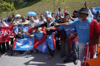 Supporters of People's Justice Party gather outside the National Palace to give support to Anwar Ibrahim in Kuala Lumpur, Malaysia, Wednesday, Feb. 26, 2020. Malaysia's ruling alliance collapsed this week after 94-year-old Prime Minister Mahathir Mohamad resigned and dozens of lawmakers defected in an audacious attempt to form a new government. The political earthquake occurred less than two years after the alliance won a historic election that ousted a corruption-tainted coalition that had ruled for 61 years. (AP Photo/Vincent Thian)