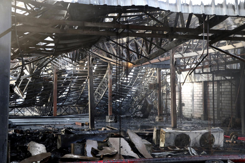 Mangled and burnt ceiling of in an amusement park is seen after a fire in Rajkot in the Indian state of Gujarat, Saturday, May 25, 2024. A massive fire broke out on Saturday in a fun park in western India, killing more than ten people and injuring some others, news reports said. (AP Photo/Chirag Chotaliya)