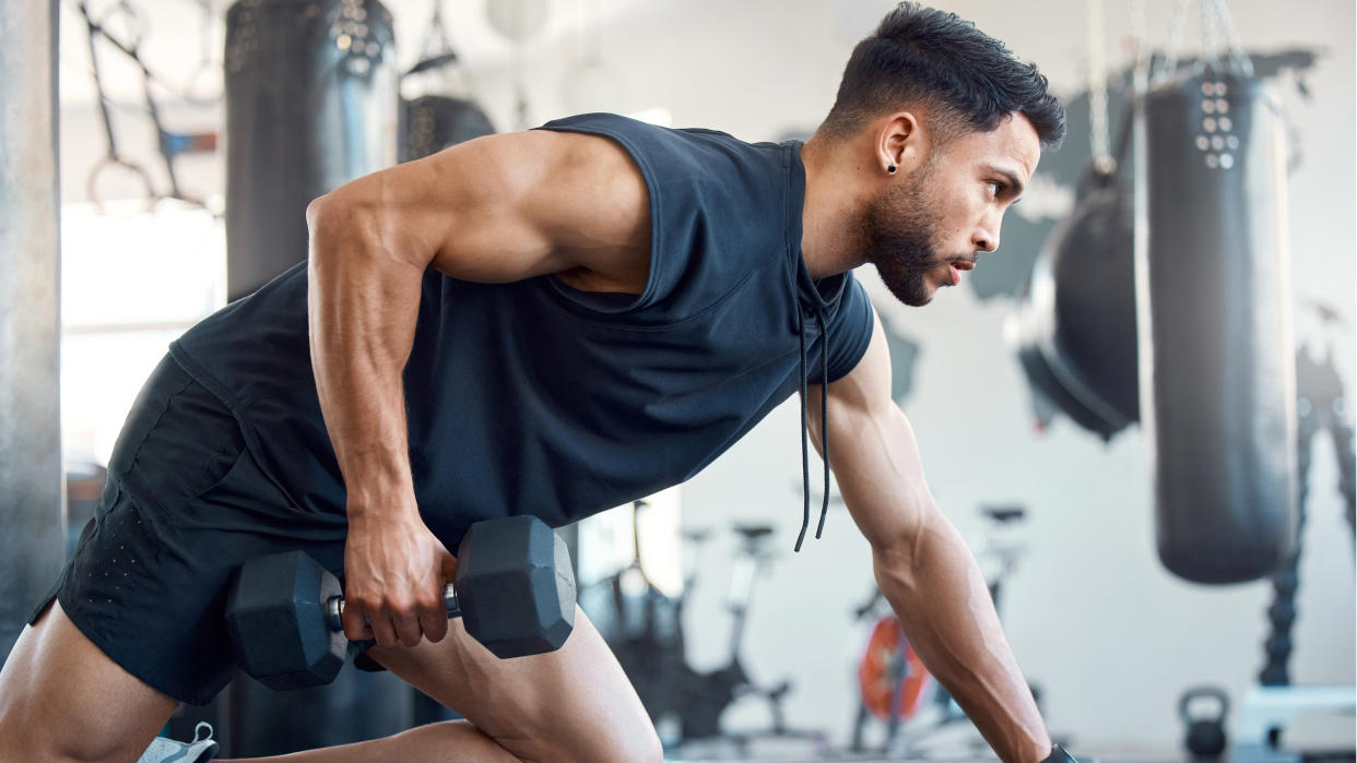  Man performing supported dumbbell rows 