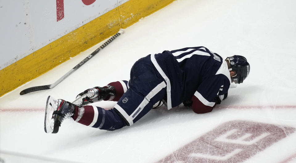 Colorado Avalanche center Andrew Cogliano reacts after running into the boards during the first period of the team's NHL hockey game against the Winnipeg Jets on Thursday, April 13, 2023, in Denver. (AP Photo/David Zalubowski