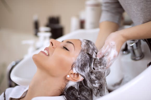 Woman getting her hair washed in salon