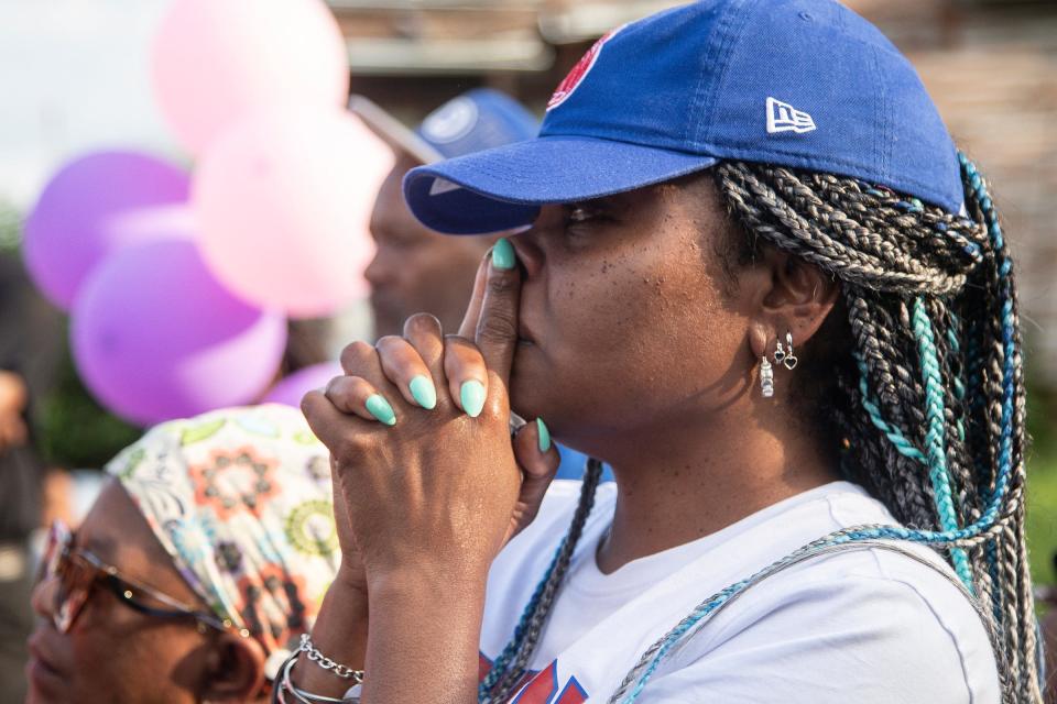 Julia Spencer, center, who has a son murdered a few years ago, bursts into tears during a community vigil on Erwin Avenue near Wynter Cole Smith of Lansing, 2, was found in Detroit on Thursday, July 6, 2023.