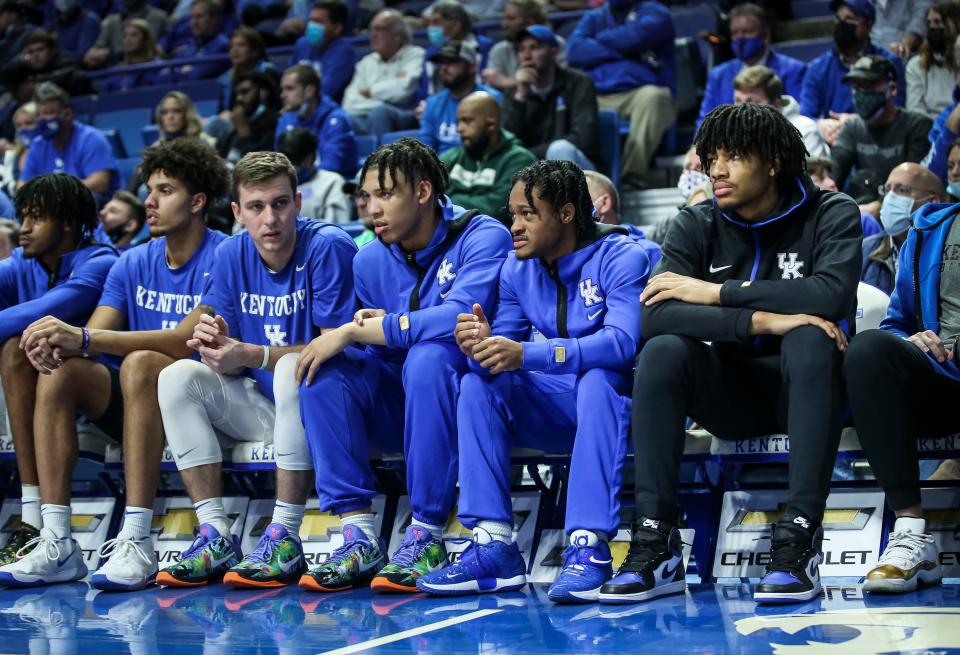 Kentucky player Shaedon Sharpe -- in black track suit -- sits on the bench during the game against Georgia January 8, 2022. January 8, 2022