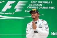 Formula One - F1 - Chinese Grand Prix - Shanghai, China - 09/04/17 - Mercedes driver Lewis Hamilton of Britain celebrates on the podium after winning the Chinese Grand Prix at the Shanghai International Circuit. REUTERS/Aly Song