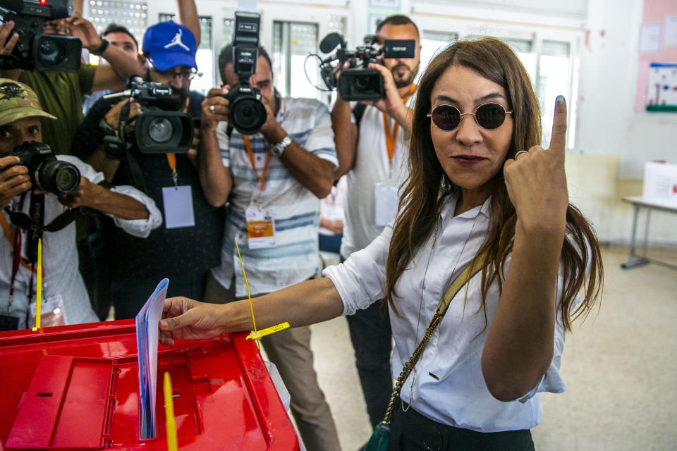 Salwa Karoui, wife of Tunisia's jailed presidential candidate and media mogul Nabil Karoui casts her ballot inside a polling station during a parliamentary election in Tunis, Tunisia, Sunday, Oct. 6, 2019. Tunisians are electing a new parliament Sunday amid a tumultuous political season, with a moderate Islamist party and a jailed tycoon's populist movement vying to come out on top of a crowded field. (AP Photo/Riadh Dridi)