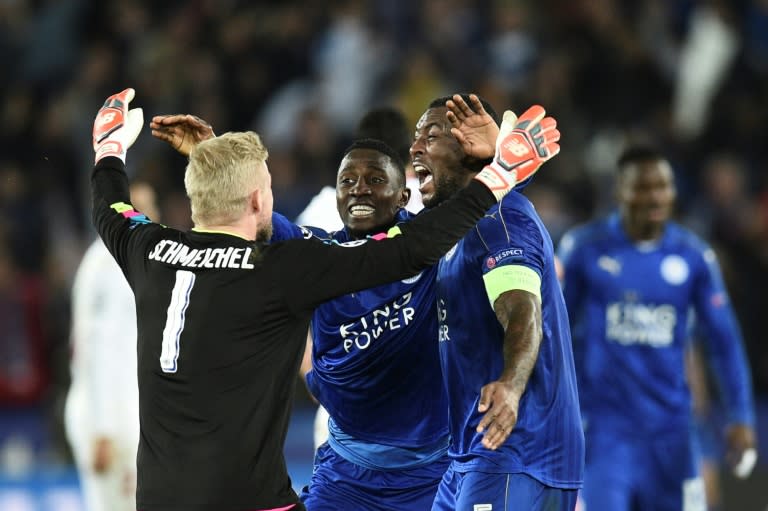 Leicester City's Danish goalkeeper Kasper Schmeichel (L) celebrates with teammates at the final whistle of their match match against Sevilla at the King Power Stadium on March 14, 2017