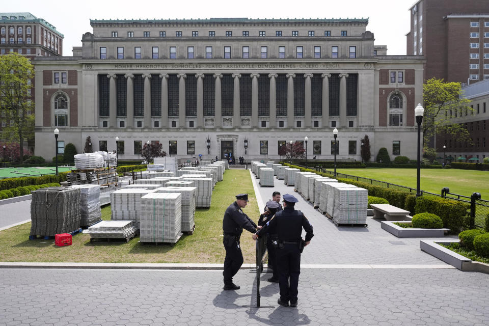 New York City police officers stand on the Columbia University campus, amongst the equipment that was to be used to host a large graduation ceremony, in New York, Monday, May 6, 2024. The university says it is canceling its university-wide commencement ceremony following weeks of pro-Palestinian protests. Smaller school-based ceremonies are still on for this week and next. (AP Photo/Seth Wenig)